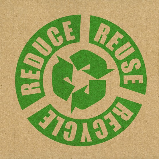 Green recycle logo with 'Reduce, Reuse, Recycle' text printed on cardboard.